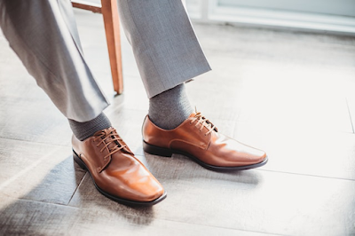 Man Wearing a Pair of Brown Leather Shoes