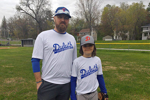 father and son in baseball uniform