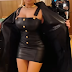 Nicki Minaj posed in a @Balmain $4,500 black leather trench coat, a $3,095 buttoned leather overall mini dress and a $1,079 monogram embossed bag. 