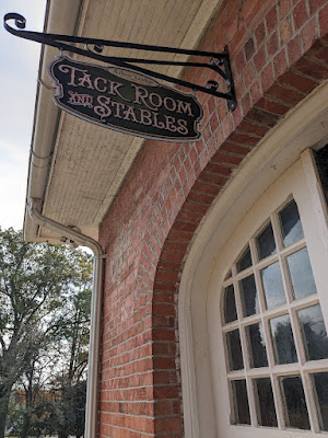 an ornate sign announces the tack room and stables at the Arbor Lodge