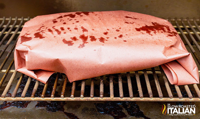 smoking brisket in pink butcher paper