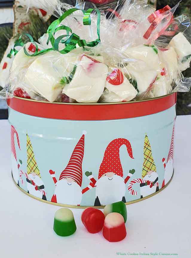 nougat in a holiday knome tin wrapped in see thru bags and ribbons