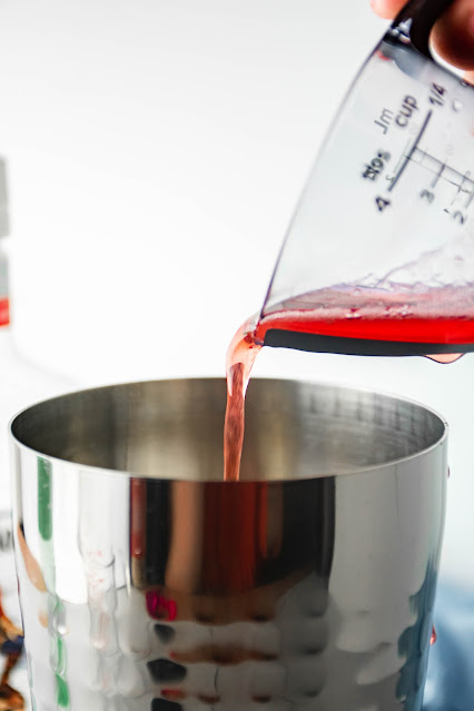 simple syrup being poured into pitcher.