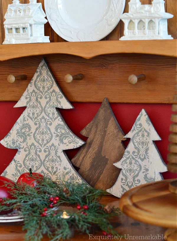 Cottage Style Crafty Christmas Trees with apples and greenery on display chest