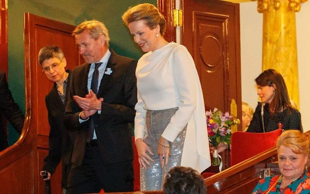 Queen Mathilde wore a silk top, blouse from Natan, and a grey silver sequin high waisted straight leg trousers from Natan