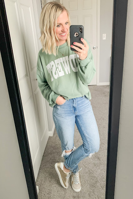 Midwest sweatshirt with mom jeans and sneakers.