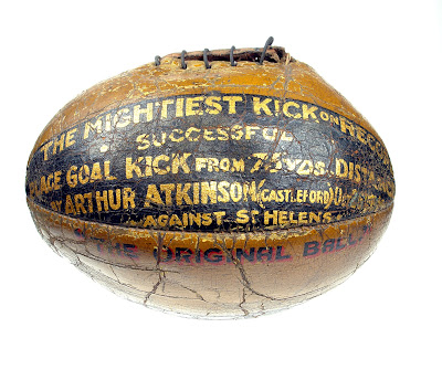 An old hand-stitched rugby ball with the details of Atkinson's achievement written on it