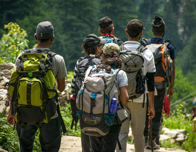 group of hikers with large backpacks in the mountain trail