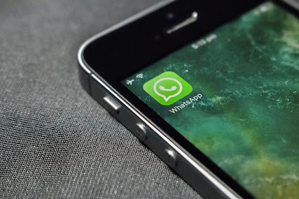 Whatsapp app is displayed on the screen of iphone