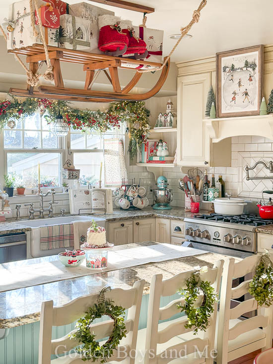 Christmas kitchen with country decor and vintage sled over kitchen island - www.goldenboysandme.com