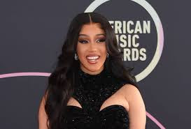 Cardi B Stones wears a Black Velvet Peekaboo dress and stiletto heels at the Biggest American Music Awards on the red carpet