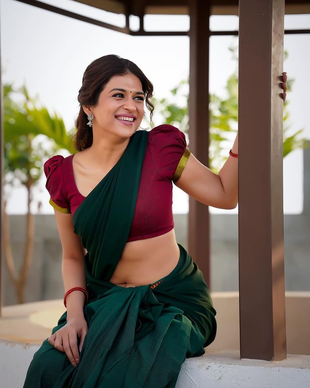 Shraddha Das: Embodying Village Girl Charm in Red and Green Half Saree.