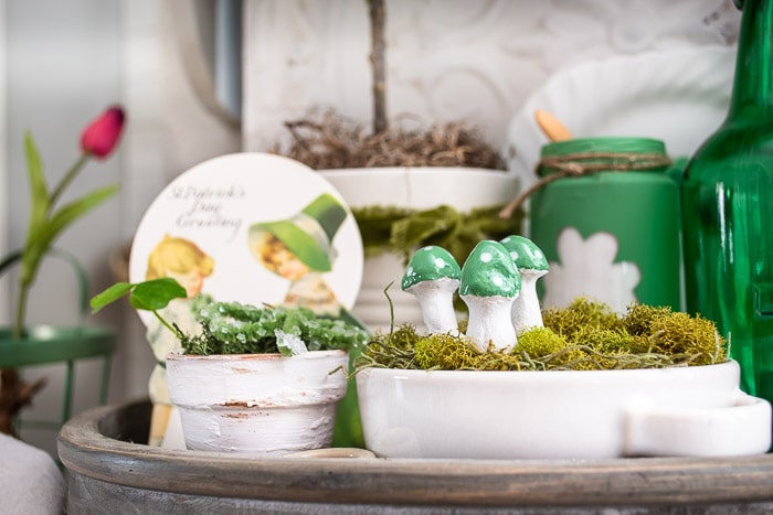 green polka dot air dry clay mushrooms in vintage St Patrick's Day vignette