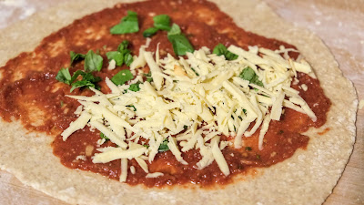 Calzone dough with tomato sauce and vegan cheese