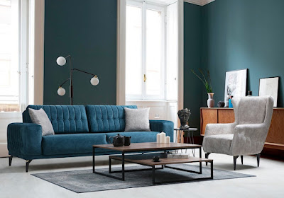 3 piece living room with teal sofa, white armchair, and a wooden coffee table