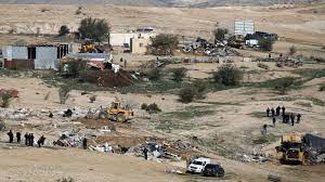 The demolition of 12,000 homes and facilities in 5 years Bulldozing and harassment is Israel's policy to displace the Negev Bedouins  Bulldozing and harassment aim to restrict the population and cut off any geographical contact between the Bedouin villages, by planting settlements and individual farms on Arab lands facing the encroaching Judaization.  Occupied Jerusalem - Sheikh Suleiman al-Atrash has passed his eighties without settling in a house that shelters his families in the village of al-Atrash in the Negev, which is engaged in a battle to confront the bulldozing and infringement (planting of woodland trees) of the lands, which the Israeli authorities have initiated in the area known as the “Beersheba Naqa’.” It includes 6 unrecognized villages.  Sheikh al-Atrash does not remember the year in which he was born, but he is sure that he is older than Israel, as he was a child - and he was the youngest of his brothers - when the catastrophe occurred in 1948, when his mother embraced him in her bosom when members of the Jewish gangs stormed the village of al-Atrash near the city of Beersheba, and barricaded himself with Her children, like many of the families of the clan, live in tents, clinging to their land in the Negev.  The population of the Bedouin in the Negev in 1948 amounted to more than 100,000 people, most of whom were forcibly displaced, as Jewish gangs migrated them to the Gaza Strip, Sinai and Jordan, while 11,000 people remained and were grouped into an area that Israel called "the fence".  The area of ​​the Negev extends to 14,230 square kilometers, or 68% of the area of ​​Palestine 48, which is 20,770 square kilometers. fallow in 1921, while today they live on 300,000 acres.   Dredging work At the beginning of this year, marking the 74th anniversary of the Nakba, the Israeli establishment began to seize and confiscate 800,000 dunams of the Bedouin residents’ ownership in the villages deprived of recognition, by resuming the razing work by the bulldozers of the Permanent Fund of Israel (Kakal), of the lands of the village Al-Atrash extends over an area of ​​45,000 acres and is inhabited by 7,000 people.  In a battle of hit and run that spanned for 3 days on the lands of the village of al-Atrash, between the young men and the special units of the Israeli police, which provided protection and guard for the bulldozers that destroyed agricultural crops and razed hundreds of dunams in preparation for their displacement, Sheikh al-Atrash moved in the confrontation arena, perhaps forming a shield and a fortress for the children and young people who were victims of attacks The repression and arrest of the Israeli police.  Despite his advanced age, the sheikh in his eighties seemed to move between the solidarity activists and the defenders of the land, with his greatest understanding of protecting young people and children from the oppression of the Israeli police.  Sheikh al-Atrash told Al-Jazeera Net, "These are our lands before the establishment of Israel, and we have title deeds from the Ottoman era, and recognition documents of our ownership of lands from the British Mandate, but Israel wants to occupy our lands and displace us."  Displacement scheme Sheikh al-Atrash - who owns 300 dunams that he inherited from his father and has been cultivating and raising livestock there - recalls decades of suffering and restrictions that included demolishing tin houses, destroying agricultural crops, spraying them with chemicals and poisoning livestock. He says, "All the policies of the Israeli authorities aimed at displacing us and confiscating our lands have failed, and have not undermined our determination and steadfastness, and it is a message that we pass on to our children and grandchildren of steadfastness and survival in the land."  Despite this steadfastness, the octogenarian Sheikh expresses his fear of what the future will hold for his grandchildren, saying, "No one knows how events will develop in the Negev, whose residents live in the scheme of displacement and focus on the least area of ​​land.  Sheikh al-Atrash - who lives with his family in a tin house - embodies the reality of the 150,000 residents of 35 villages not recognized by Israel, out of the 300,000 Arabs living in the Negev, where the residents are fighting a battle to preserve existence, with the launch of the Israeli government The "green settlement" project in the heart of Bedouin residential communities, with the establishment of 12 new settlements and dozens of individual farms for Jews.  Battle of the Negev Despite the Nakba, the head of the “citizen” movement in the Negev, Abed Abu Kaf, says, “Israel has not won the battle in the Negev desert. the earth".  Abu Kaf explains to Al Jazeera Net that the bulldozing of lands in the villages stripped of recognition is another facet of the slow displacement of the Bedouin population, and their robbery of their lands and their use for settlement and Judaization projects, saying that "the Israeli establishment has declared war on the Bedouins in the Negev, so what is happening is ethnic cleansing, through demolition, bulldozing, and uprooting." Displacement of residents in the open, in order to force them to live in fixed towns.  In an effort to impose sovereignty on Bedouin lands and confiscate them and gather the population on the least amount of land, Abu Kaf says, “In the early seventies of the last century, the Israeli authorities announced the decree of land settlement and registration of state ownership.” They also established 9 stable towns and villages to group and concentrate the Bedouins, namely: Rahat Lakiya, Kuseifa, Hura, Tell Al-Sabaa, Ararat Al-Naqab, Shaqib Al-Salam, Al-Qaisum Council, and the Desert Oasis Council.  Today, Abu Kaf says, "Israeli towns and Jewish regional councils in the Negev control 12,000 square kilometers, which constitutes 86% of the area of ​​the Negev, and the recognized Arab local authorities have only a small part of its area that does not exceed 150,000 dunams, and the same for villages that have been stripped of recognition." Which constitutes about 2% of the area of ​​the Negev.  Creeping lullaby For his part, the head of the Regional Council for Unrecognized Villages, Attia Al-Asam, reviews Israeli plans at the expense of the Arab presence in the de-recognized villages whose residents own more than 800,000 dunams.  Al-Asam warns - in his speech to Al-Jazeera Net - of the repercussions of the razing of lands in the Negev, especially in the villages stripped of recognition in the "fence" area.  He asserts that the bulldozing and harassment of lands aims to restrict the population and cut off any geographic communication between the Bedouin villages, by planting settlements and individual farms on Arab lands facing the encroaching Judaization.  Al-Asam explains that the bulldozing and harassment of lands are in addition to the demolitions carried out by the Israeli authorities, as between 2015 and 2020, more than 12,000 homes and residential facilities were demolished in the villages stripped of recognition, while the establishment of 12 new settlements and dozens of individual farms for Jews were announced.  He points out that the Israeli authorities are targeting the Arab presence in the Negev, and are adopting a policy of creeping displacement with the residents of villages stolen from recognition in order to force them to migrate and gather them in existing towns on the least amount of land. He stressed that the consensus in the Negev is to reject any settlement, to insist on Israeli recognition of the villages stripped of recognition, and to establish the Bedouin citizens' ownership of 800,000 dunams.