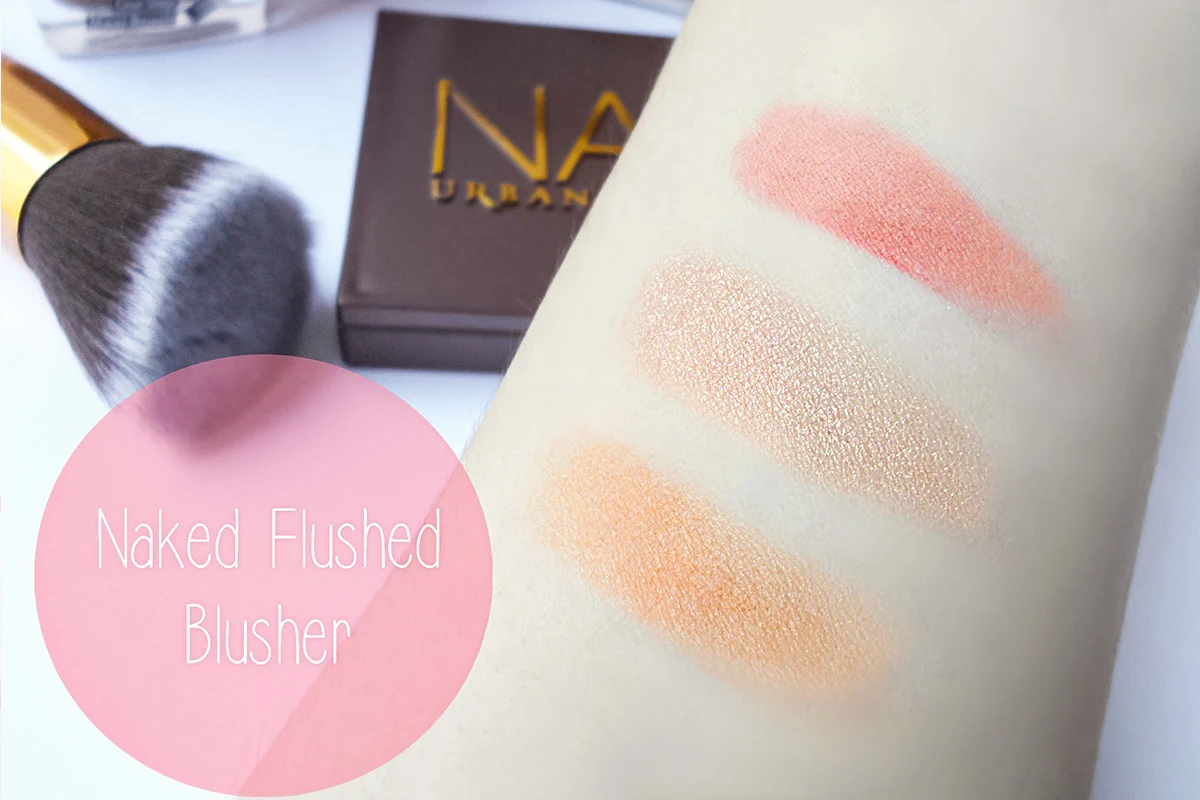 a close-up swatches on the light skin of colors and texture of naked flushed palette by urban decay