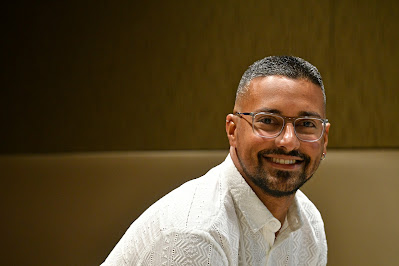 Dr. Emmanuel Santa-Martinez sitting and smiling.