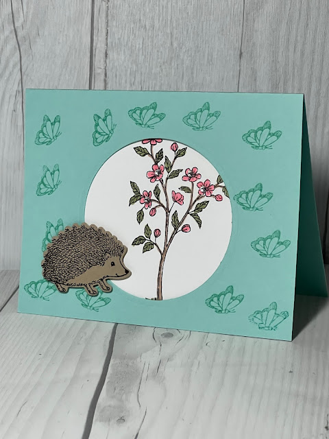 A cute handmade greeting card with a Hedgehog, butterflies and a blooming tree using Stampin' Up! Happy Hedgehogs Stamp Set and the Hedgehog Builder Punch
