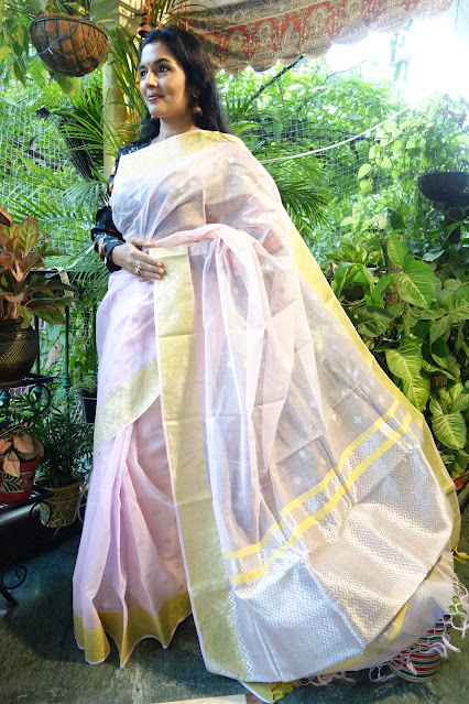 Simple baby pink saree with heavy borders and butis.