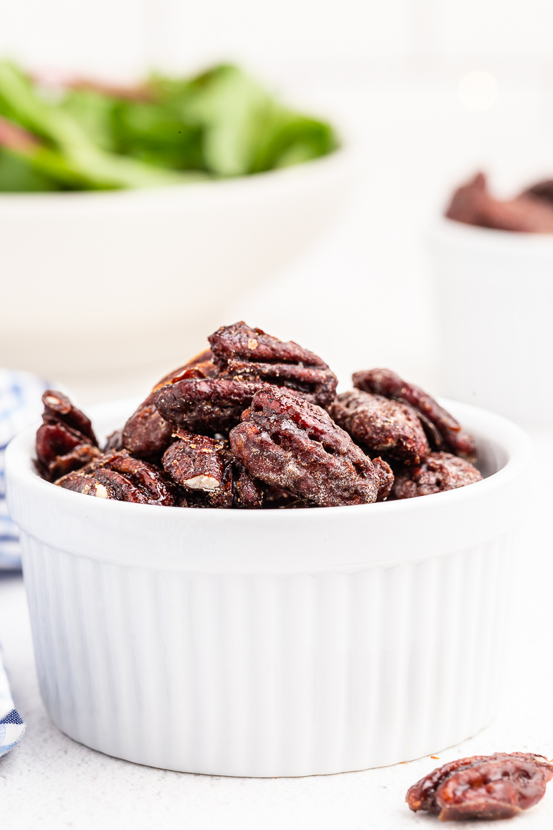 Photo of keto candied pecans in a small white serving bowl.