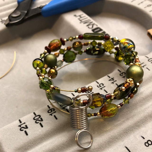 Gluing the last few beads to one end of the memory wire
