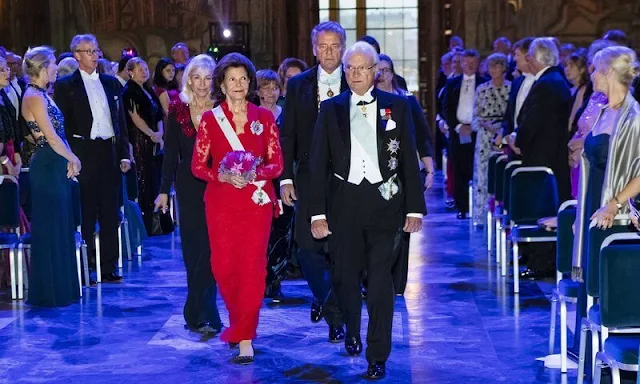 Royal Swedish Academy of Engineering Sciences. Queen Silvia wore a red lace dress. Van Cleef and Arpels flower earrings
