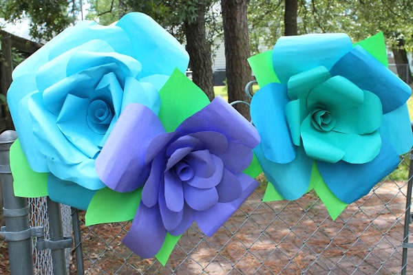 Make giant paper flowers out of glitter paper and hot glue. Inexpensive crafts will have a big impact.
