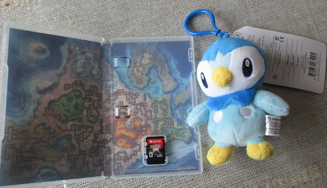 Pokémon Shining Pearl inside Nintendo Switch box art Sinnoh Grand Underground Piplup keychain plush plushie