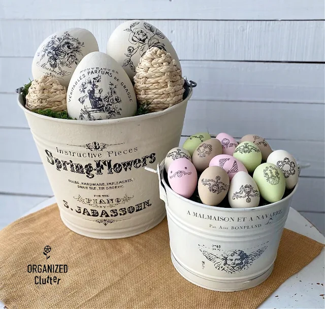 Photo of large paper mache eggs chalk painted and decorated with decor transfer labels from Redesign with Prima.