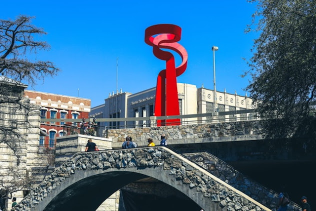 A red statue by the San Antonio riverwalk