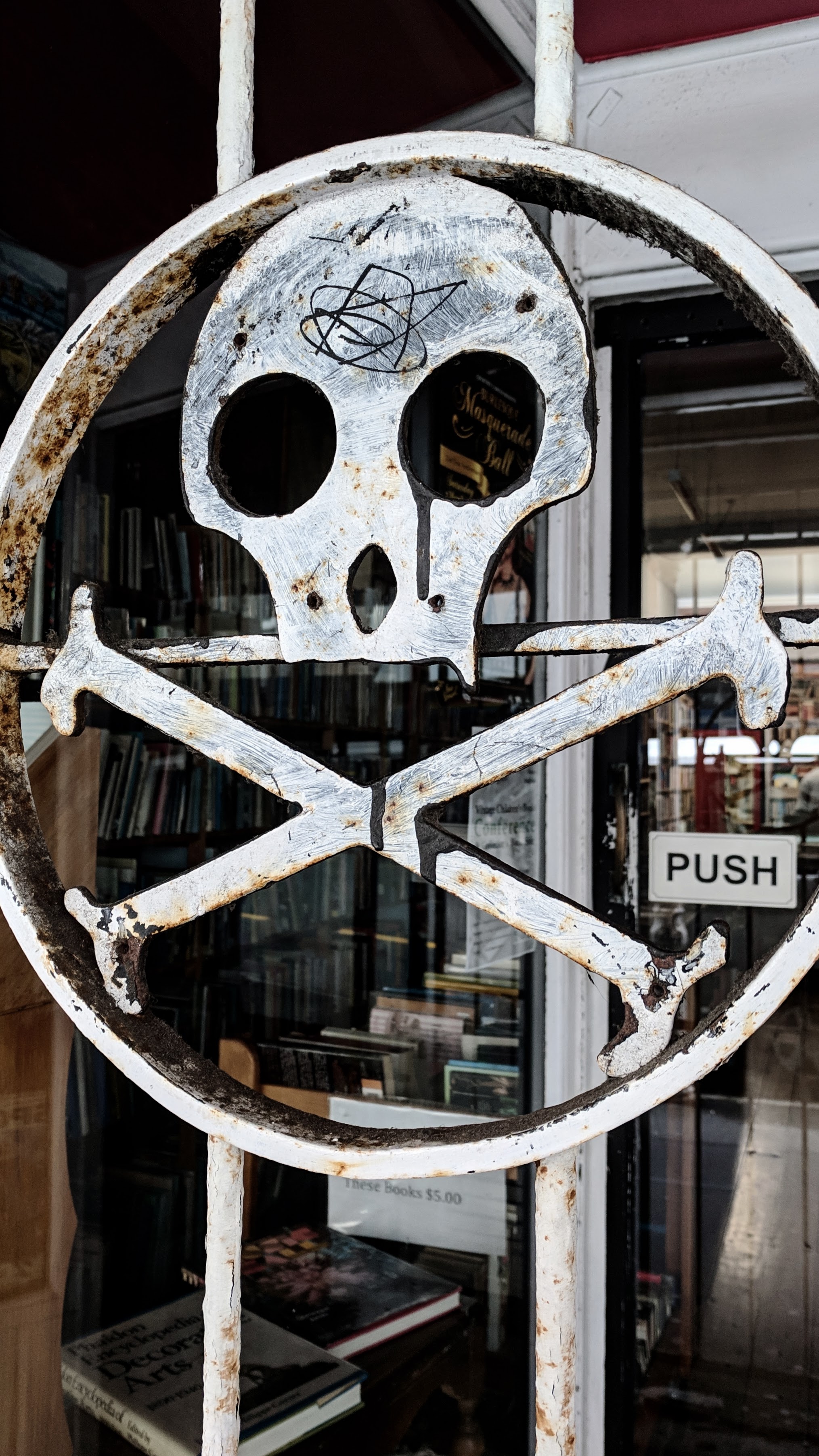 Metal skull on shop gate