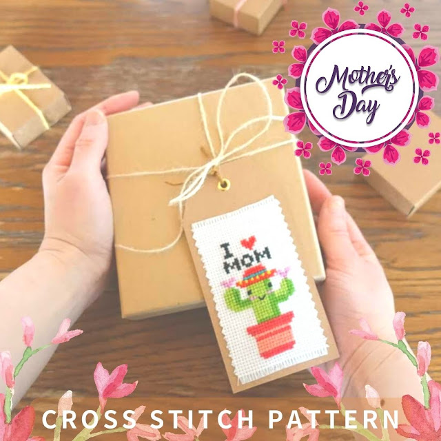 A mother is receiving a cross-stitch gift tag of a cactus.