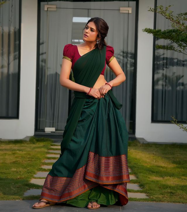 Shraddha Das: Embodying Village Girl Charm in Red and Green Half Saree.