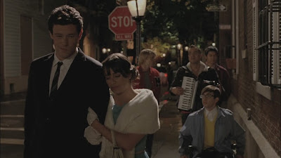 Rachel and Finn walking with Artie, Puck, Sam, and Mike following them and singing