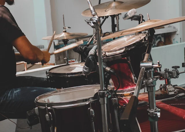 A man playing drums in his home studio