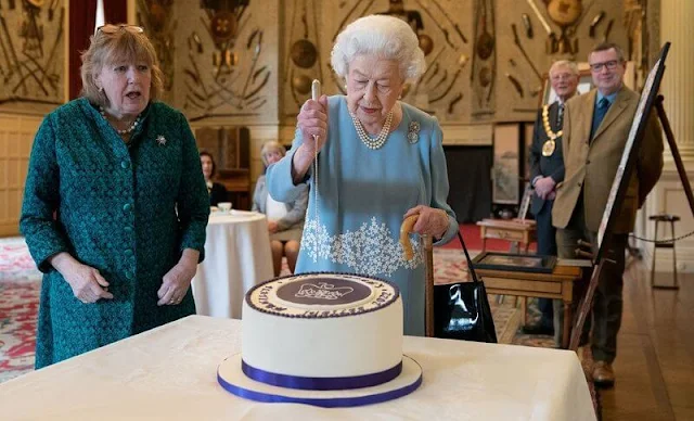 Queen Elizabeth wore a wedgewood blue crepe and a white brocade embroidered blue dress by Angela Kelly