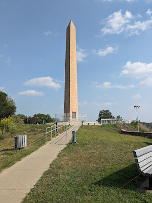 view of Floyd Monument from below, with blue sky behind