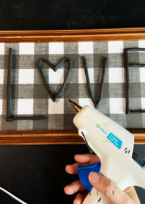 Hot glue clay letters onto the front of the frame to make Valentine's art