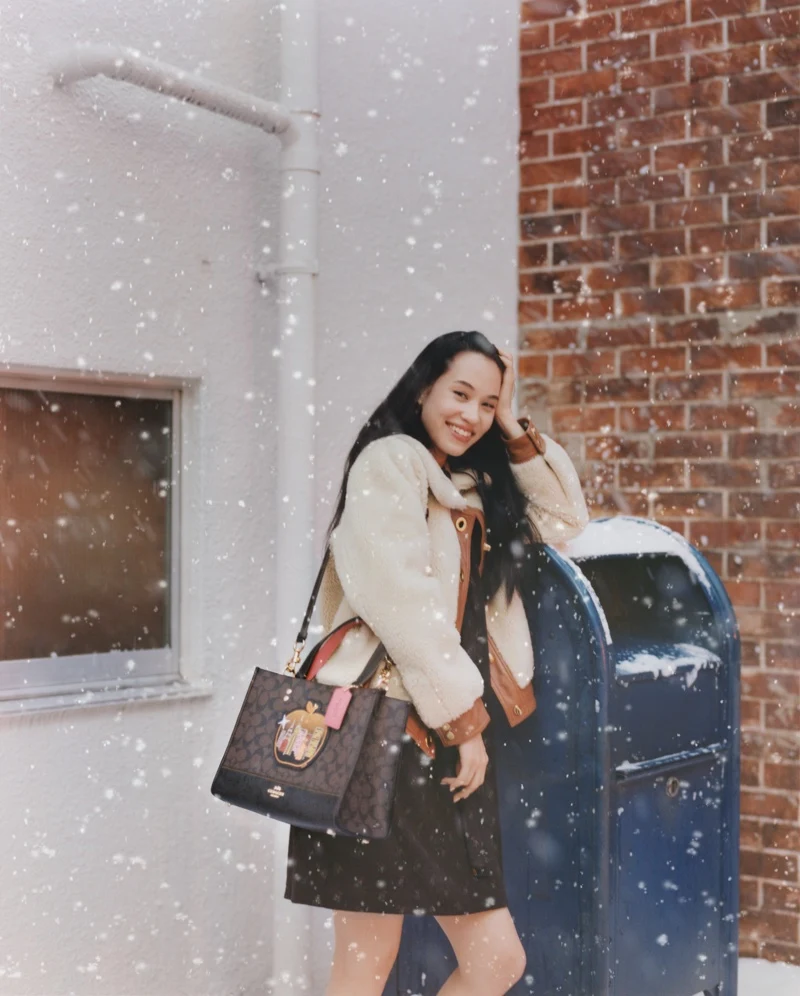 Posing in the snow, Kiko Mizuhara fronts Coach Holiday 2021 campaign. Photo: Courtesy of Coach