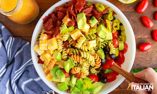 chicken bacon pasta salad tossed in a bowl