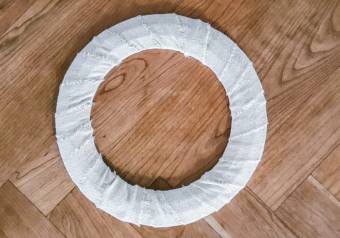 wire wreath form completely wrapped in drop cloth