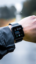 A black strapped Apple watch around ones wrist.