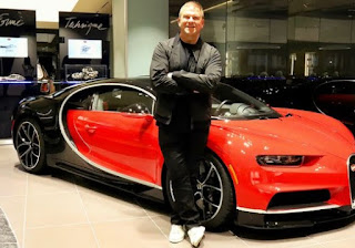 Tilman Fertitta posing for picture with a classic car