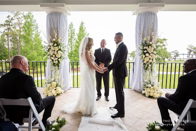 bride and groom holding hands at altar