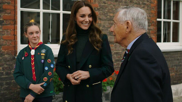 Kate Middleton wore a double breasted coat by Holland Cooper and a merino turtleneck sweater and midi skirt by Iris & Ink. Emily Edge