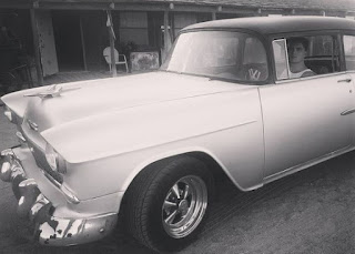 Chelsea Thea Pagnini's husband Zane sitting inside the classic car