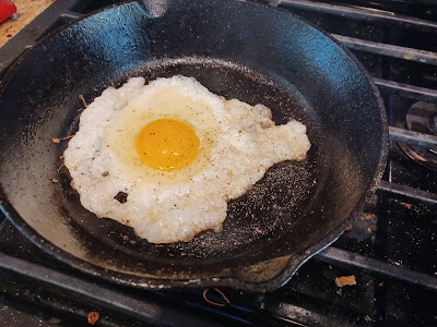 crispy frying egg in a small cast-iron skillet