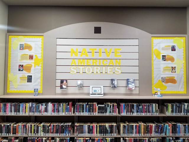 Photo of books and yellow and white bulletin board displaying books by Native authors
