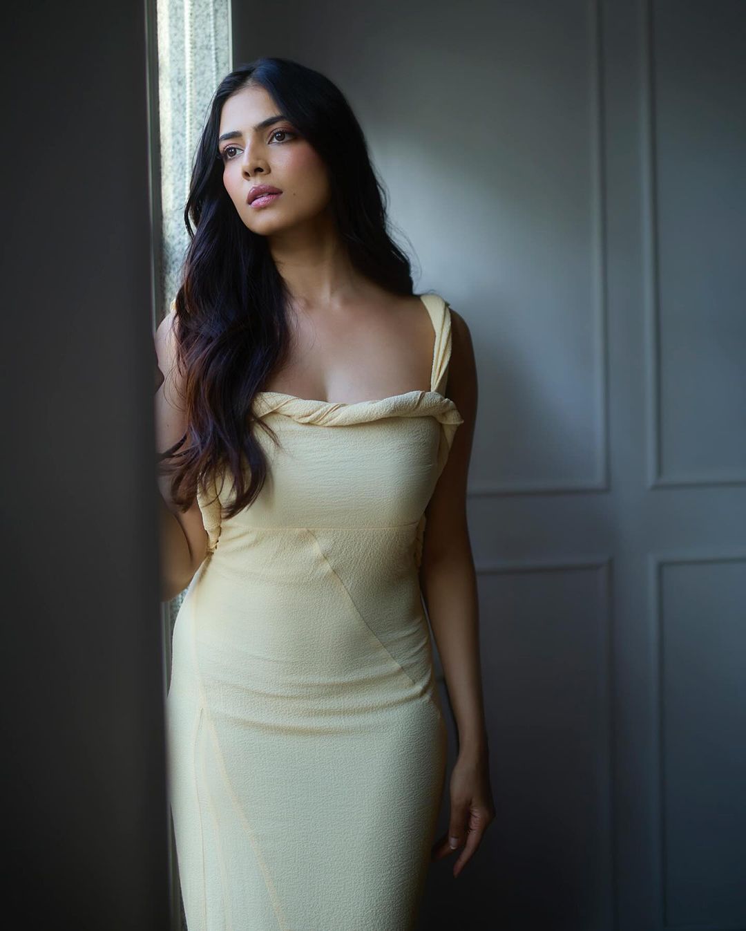 Malavika Mohanan's Sensational Photoshoot in a Cream-Colored Strappy Long Dress